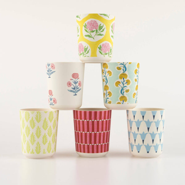 Set of six colorful patterned cups stacked on a white background