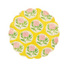 Round yellow small plate with pink, green and white floral design and wavy edge on a white background
