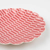 Pink wavy patterned plate on a white background