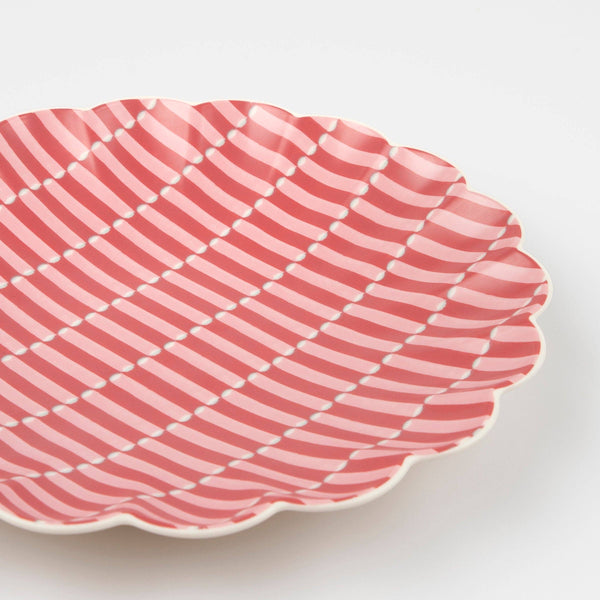 Pink wavy patterned plate on a white background