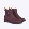 A pair of dark cherry red ankle height rain boots with tan pull tabs and black soles against a white backdrop.