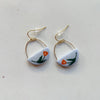Glossy light blue polymer clay earrings in a half circle shape hand-painted with a red and dark green flower motif. These hang from gold wire arcs and gold hooks.