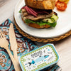 Sandwich with sardines on a plate with a can of sardines in olive oil in the foreground.