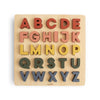 Wooden alphabet puzzle with colorful letters on a beige background