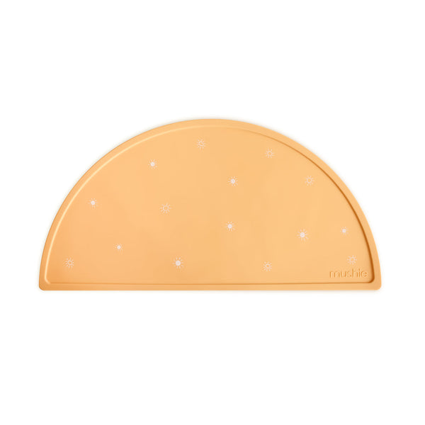 Orange half-moon placemat with white sunbursts on a white background