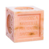 Orange scented orange-pink square cube of soap with text on a white background