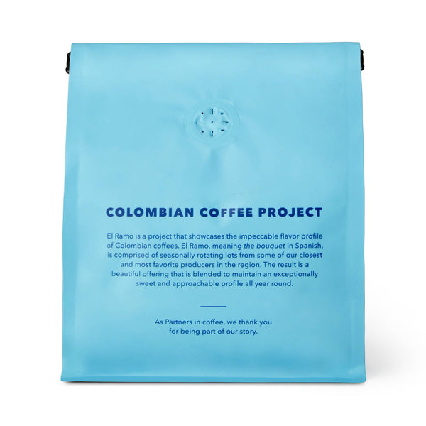 Blue coffee package with text about the Colombian Coffee Project on a white background