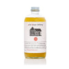 Bottle of Pink House Alchemy's Pineapple Rosemary shrub.