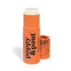 A pink-orange tube of Peach Creme lip balm by Poppy & Pout