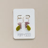 A pair of gold hoop earrings with lilac and chartreuse floral clay drop accents. 