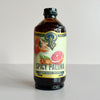 A bottle of Portland Syrup 'Spicy Paloma' premium beverage concentrate, featuring a cream-colored label with illustrations of citrus fruits, set against a plain light gray background.