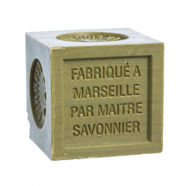 Cube-shaped dark green olive oil soap with 'Fabriqué Marseille par Maitre Savonnier' text on a white background