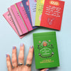 Set of illustrated cards with a hand holding one card against a light blue background