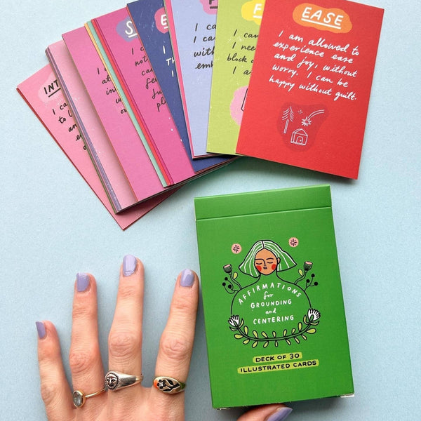 Set of illustrated cards with a hand holding one card against a light blue background