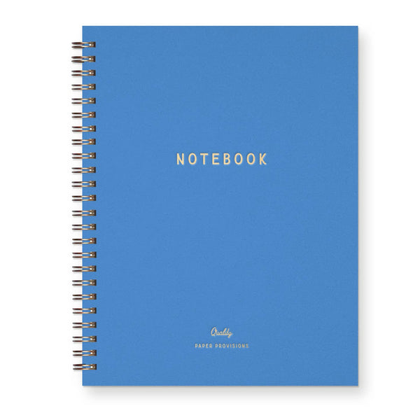 Blue notebook journal with gold foil print and wire binding on a white background.