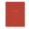 Red notebook with gold text on a white background