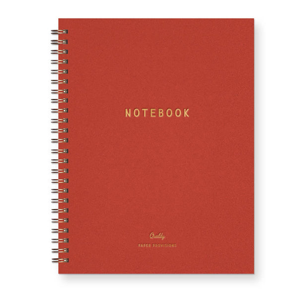 Red notebook with gold text on a white background