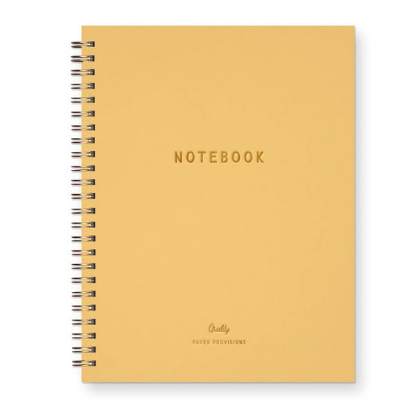 A yellow spiral-bound notebook with 'NOTEBOOK' gold foil printed in the center and 'Quality PAPER PROVISIONS' at the bottom, shown on a white background.