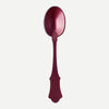 A large deep reddish-purple acrylic serving spoon against a white background.