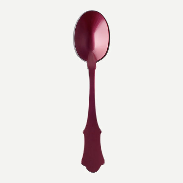 A large deep reddish-purple acrylic serving spoon against a white background.