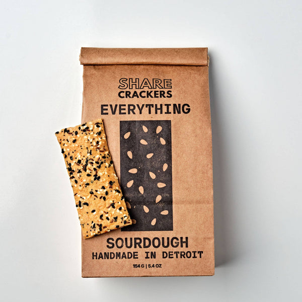 Bag of 'Everything' Share Crackers with two crackers on a light gray background