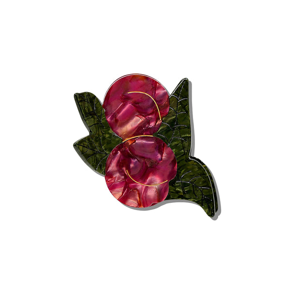 A hand-painted claw hair clip in the shape of two Japanese plums and leaves in rich iridescent red and green with gold accents, photographed on a white background.