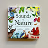 A children's educational interactive book called 'Sounds of Nature' with colorful nature and animal illustrations and a small hole showing a speaker rests on a neutral background.