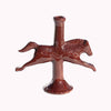 Dark brown ceramic horse shaped taper candle holder against a white background.