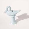 Light blue ceramic swan-shaped taper candle holder on a white background