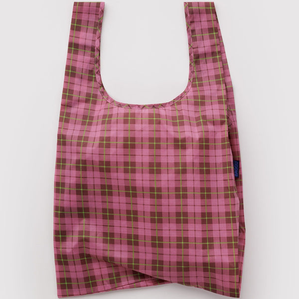 A nylon shopping bag in a deep pink and green plaid pattern against a white backdrop.