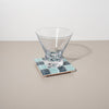 Clear glass on a mosaic coaster with a white background