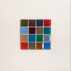 A glass mosaic tile coaster in a rich array of colors against a neutral background.