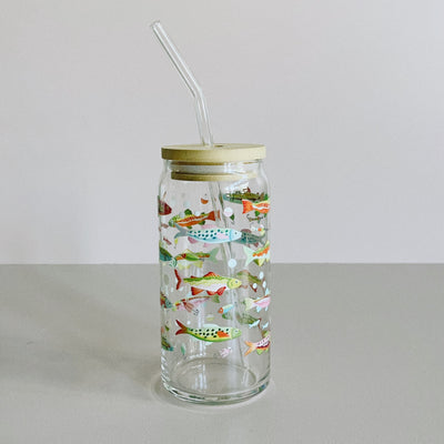 A glass travel cup with bamboo lid and glass straw. The cup is printed with a colorful fish design.