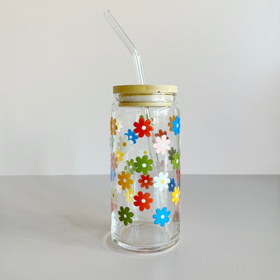 Glass travel cup featuring a colorful floral screen print. The cup has a bamboo lid and glass straw. 