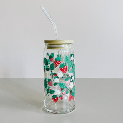 A glass travel cup with bamboo lid and glass straw. The cup is printed with a colorful strawberry floral vines design. 