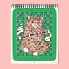 Wire-bound wall calendar with a cat illustration and 'Meow Monthly 2027' text on a green tile patterned background, against a soft pink surface.