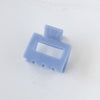 Light blue rectangular hair clip on a white background