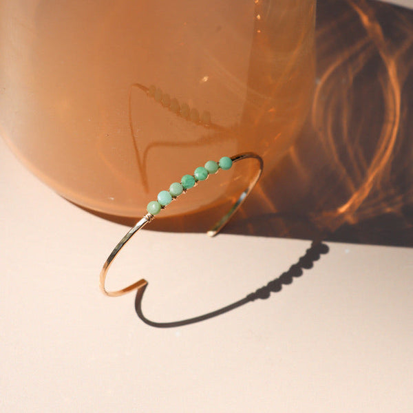 Bracelet with green chrysoprase beads on a neutral background