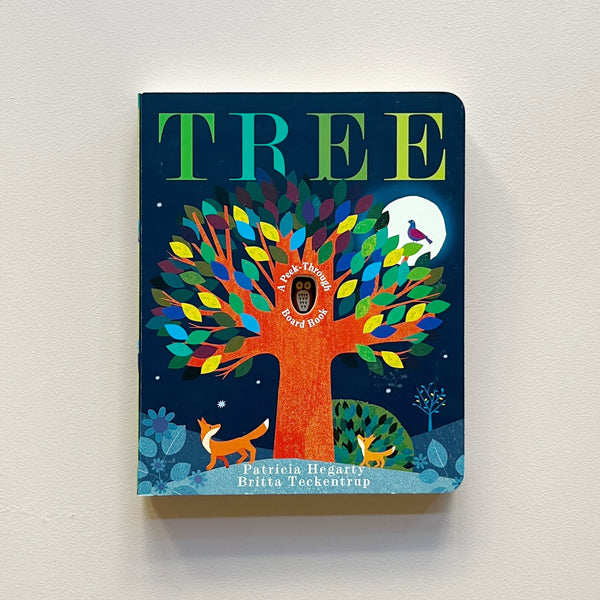 A kid's board book called 'Tree' with an illustration of a colorful tree at night under a full moon surrounded by animals. The book sits against a neutral backdrop.