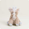 A plush goat stuffed animal, sitting upright against a plain light beige studio background. The toy has a soft fuzzy body in warm beige and tan tones, with a white face, white hooves, and small white horns.