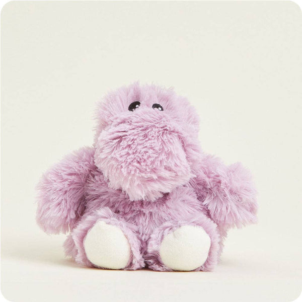 A soft, fuzzy purple hippo plush toy with white feet, sitting against a plain cream-colored background.