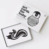 An open box of art cards for baby with black and white illustrations of animals on a white background