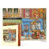 Jigsaw puzzle box with a colorful illustration of a small town autumnal street scene featuring a cafe and general store.