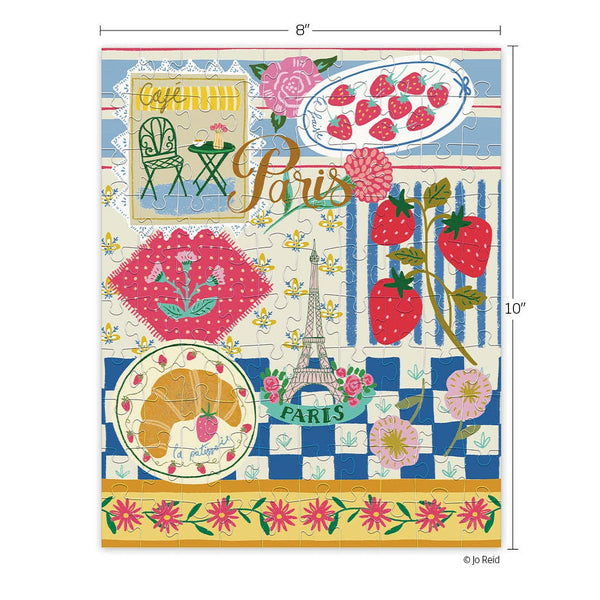 Colorful Paris-themed puzzle with Eiffel Tower and strawberries on a blue and white checkered background. This image shows the 8" by 10" dimensions. 