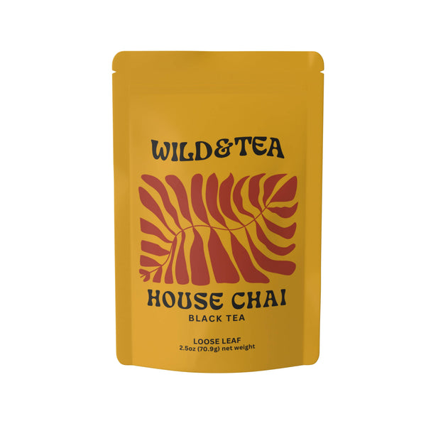 Yellow package of Wild & Tea House Chai black tea with red leaf design on a white background