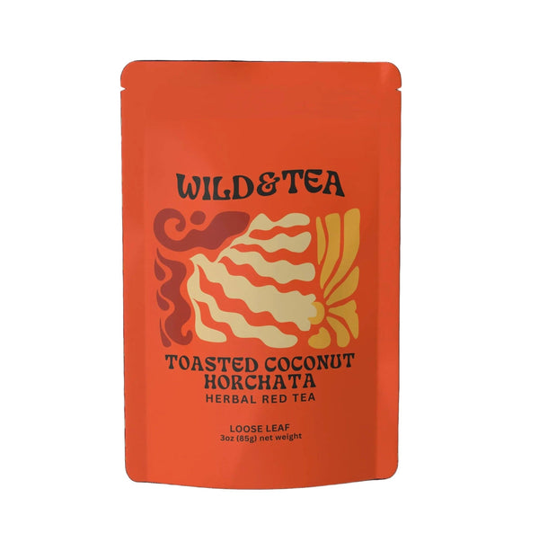 A bright orange stand-up pouch of Wild & Tea Toasted Coconut Horchata Herbal Red Tea loose leaf, featuring a stylized graphic of a coconut with red, orange, and cream stripes, on a plain white background.