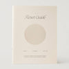 A cream-colored book titled 'The Reset Guide' with a minimalist design featuring a large beige circle on the front cover, photographed against a light gray background.