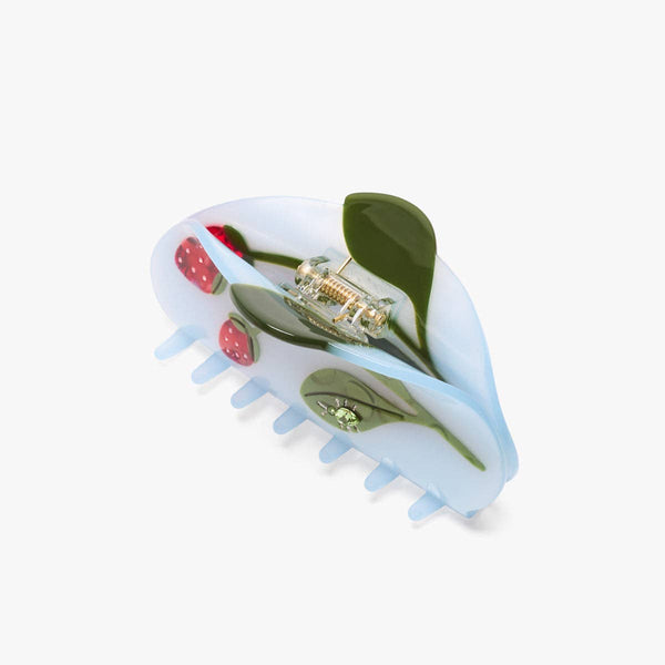 Hair claw with strawberry and leaf design on a white background