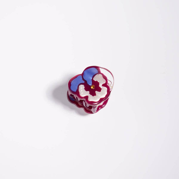 Colorful flower-shaped micro mini hair claw on a white background