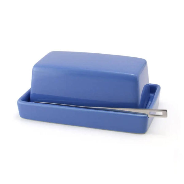 A blue ceramic butter dish with a matching lid and a silver metal knife resting across the front, set against a plain white background.